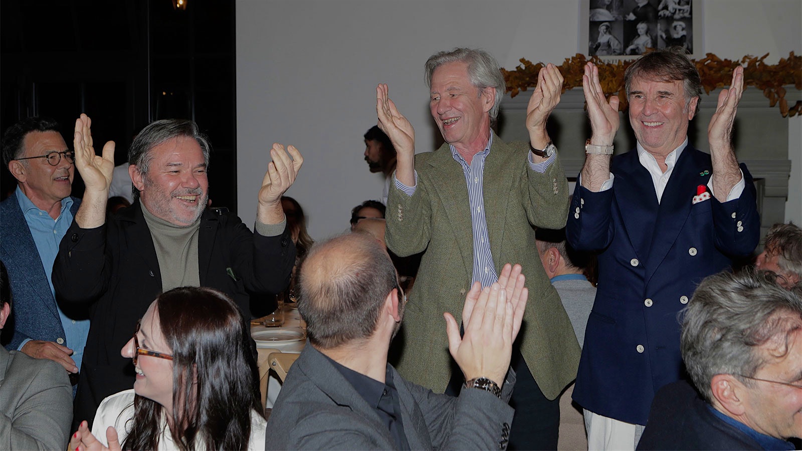 Brunello Cucinelli (right) learns the traditional Burgundy Ban Bourgignon song from Guillaume d'Angerville (center) and chef Michel Troisgros (left).